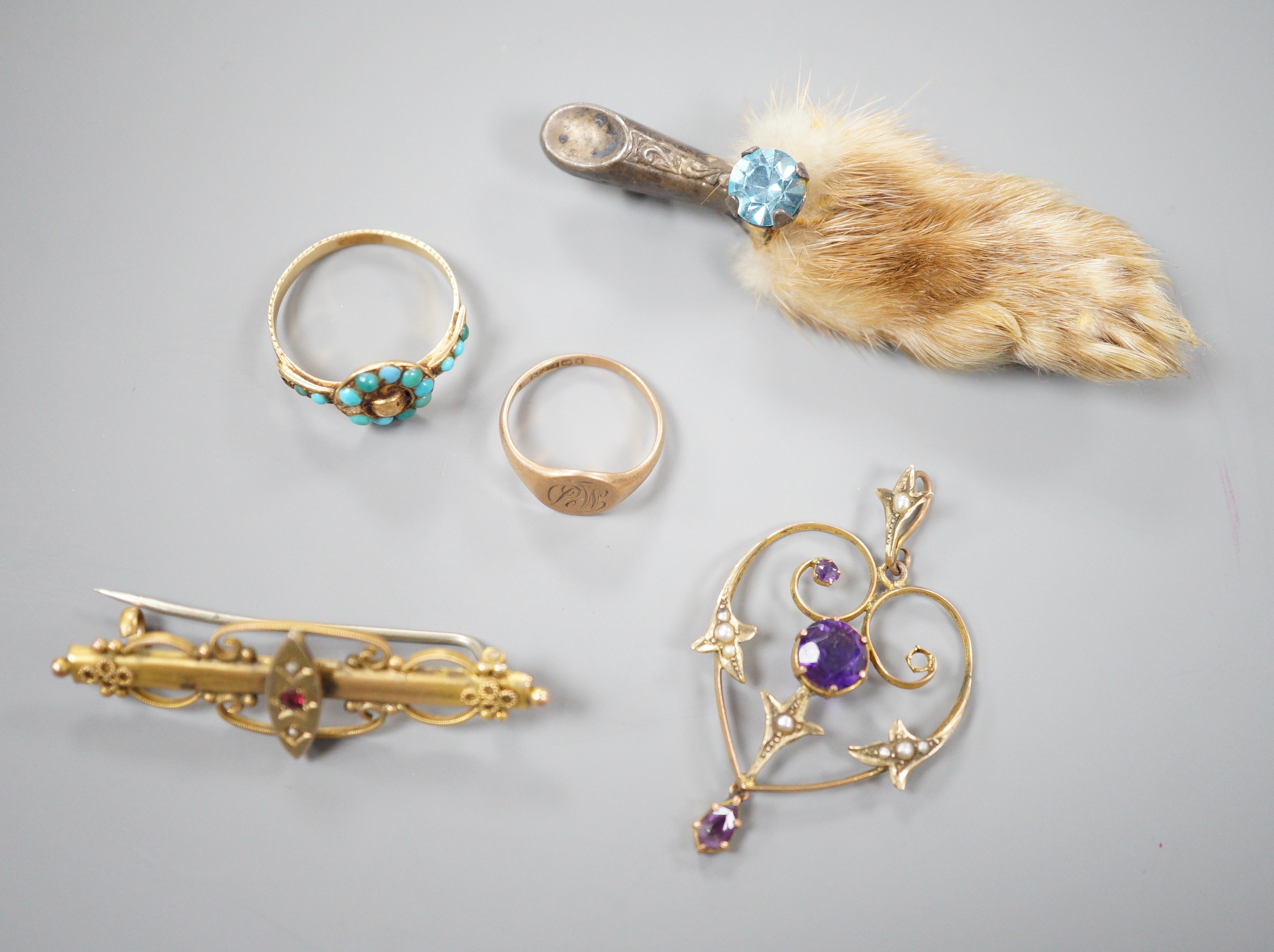 A small collection of jewellery to include an Edwardian amethyst and seed pearl pendant, two rings including Victorian yellow metal and turquoise 'buckle' ring, a bar brooch and a paw brooch.
